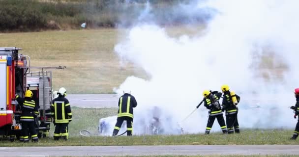 Grupp Brandmän Släck Brinnande Bil Med Slangar Med Vitt Skum — Stockvideo