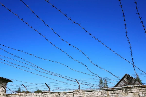 Wall with barbed wire - walking yard for prisoners