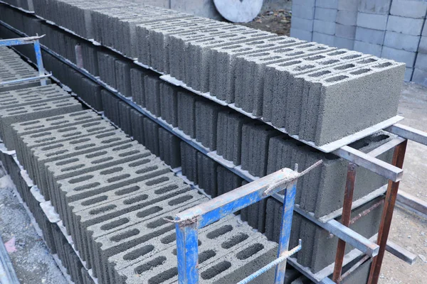 Stacking of concrete blocks laying on the floor at the factory ready to be transported to construction site - construction materials