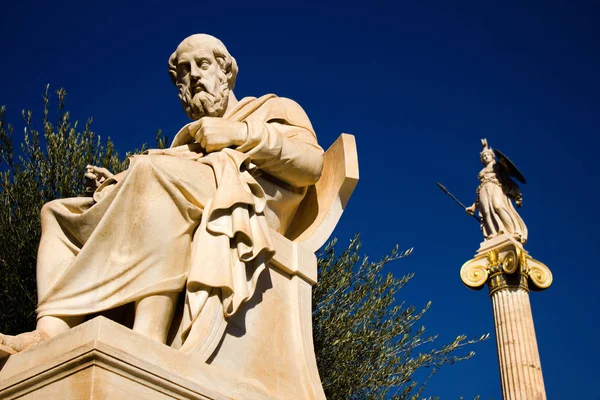 The statues of the ancient Greek philosopher Plato and Greek Goddess Athena outside of the Academy of Athens, Athens, Greece.