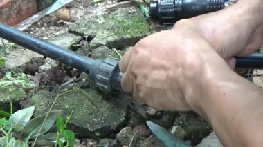 Çiftçi sebze bahçesi için su boruları kuruyor