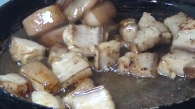 Domuzu parçalara ayır, eti baharatlarla terbiye et ve eti bir tencere yağda kızart.