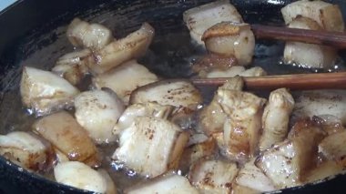 Domuzu parçalara ayır, eti baharatlarla terbiye et ve eti bir tencere yağda kızart.