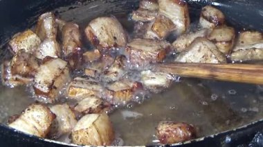 Domuzu parçalara ayır, eti baharatlarla terbiye et ve eti bir tencere yağda kızart.