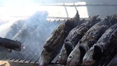 fishermen grill fish, shrimp, mussels, on the boat