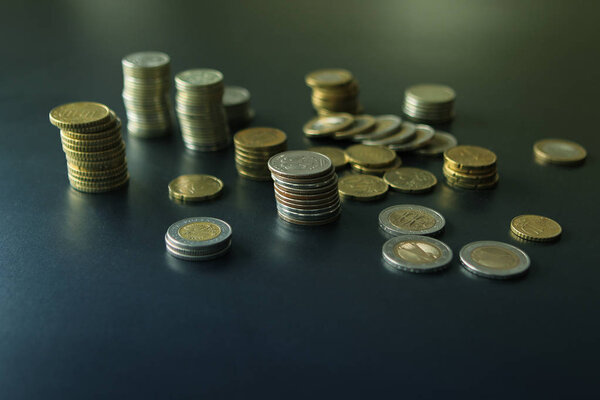 Closeup of silver and copper coins of all states on a dark background