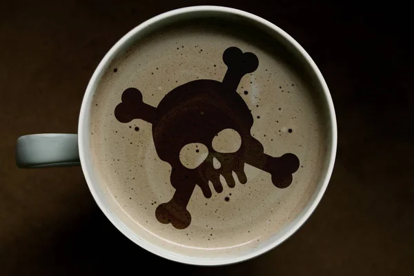 Top view of a cup of cappuccino coffee on the background, art for poison. Concept of danger. — Stock Photo, Image