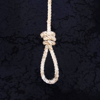 Rope for gallows with hangman noose and hanging knot isolated on a dark background clipart