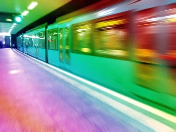 The train travels at high speed along the platform, artistically blurred image