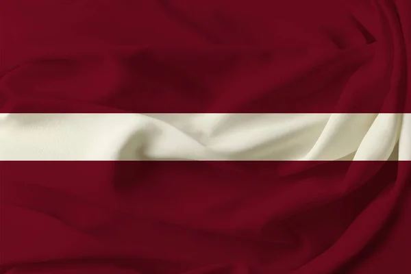 Beautiful colored flag of Latvia on pleated silk fabric — Stock Photo, Image