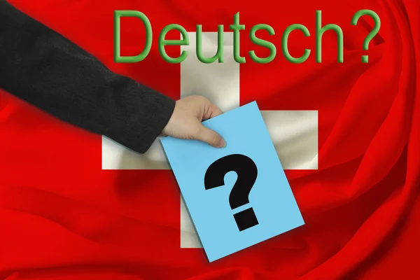 Räcka av lärare rymmer en täcka med en ifrågasätta markerar på bakgrunden av inskriften i tysk "tysken?" och härligt sjunka av Schweitz på veckat tyg — Stockfoto