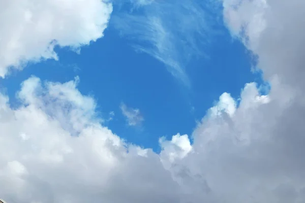 beautiful blue sky with gentle clouds, in the center of the copy space