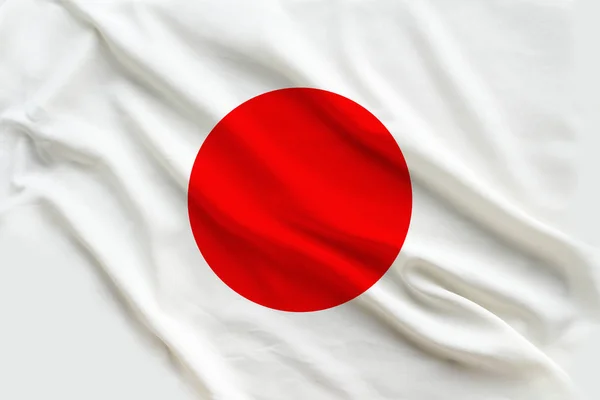 Beautiful flag of Japan on delicate silk with light folds — Stock Photo, Image