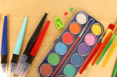 Okul çeşitli renk Kırtasiye, boyalar, kalemler, açık ahşap masa arka planda. öğrenme sanat kavramı, üst görünüm, kopya alanı