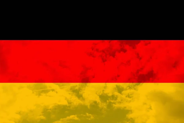 Beautiful national flag of Germany on a translucent blue sky background, close-up, copy space — Stock Photo, Image