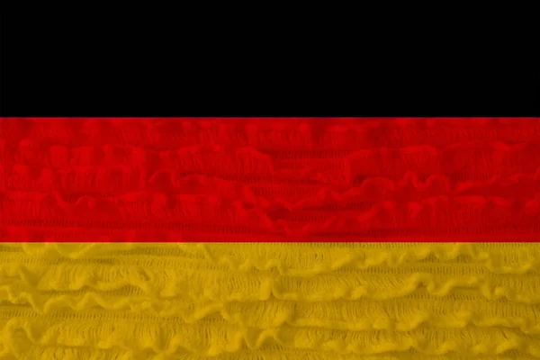 Hermosa bandera nacional del país de Alemania en el fondo de una textura suave de lana de punto con pequeños volantes de lona — Foto de Stock