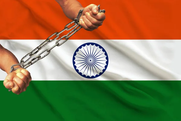 men\'s hands chained in heavy iron chains against the background of the flag of India on a gentle silk with folds in the wind, the concept of the human rights movement