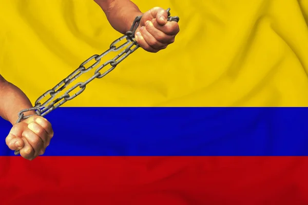 men\'s hands chained in heavy iron chains against the background of the flag of Colombia on a gentle silk with folds in the wind, the concept of the movement in support of human rights