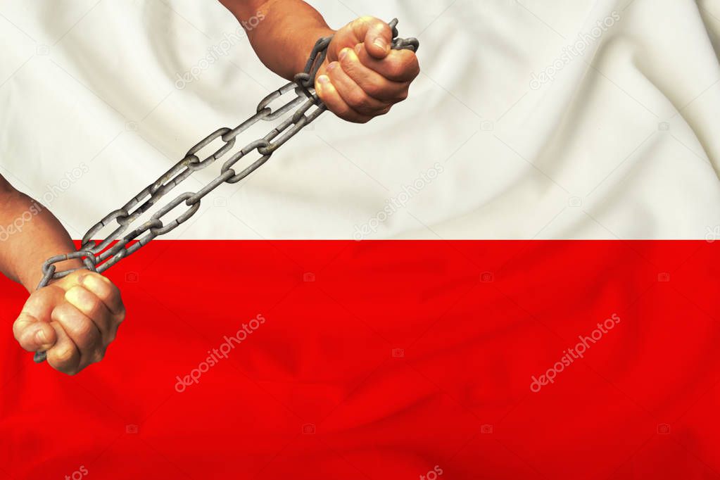 men's hands chained in heavy iron chains against the background of the flag of Poland on a gentle silk with folds in the wind, the concept of the movement in support of human rights
