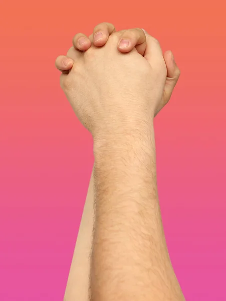 two entwined arms raised up on a pink, coral background