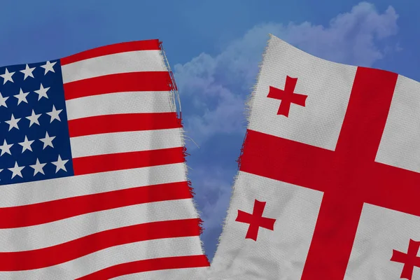 two national flags of america and georgia are torn apart by fabric, close-up, concept of diplomatic break, political and economic relations between countries