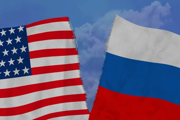 Two national flags of Russia and America are torn apart by fabric, close-up, the concept of a diplomatic gap, political and economic relations between countries