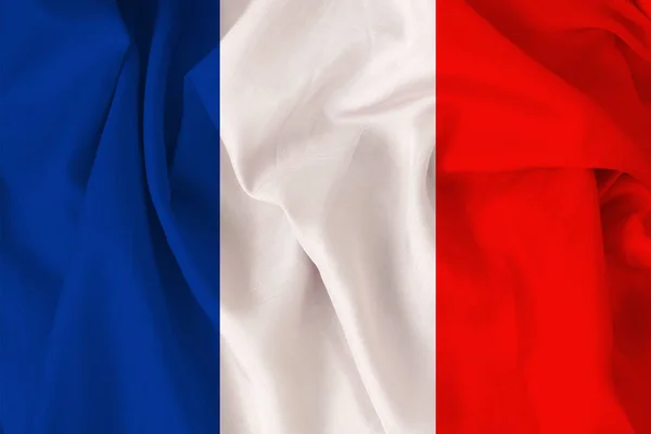 Beautiful national flag of France on soft silk with soft folds, close-up, copy space — Stock Photo, Image