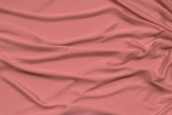 Textura del hermoso jersey de seda de coral cubierto con delicados pliegues, aislar, primer plano, espacio de copia — Foto de Stock