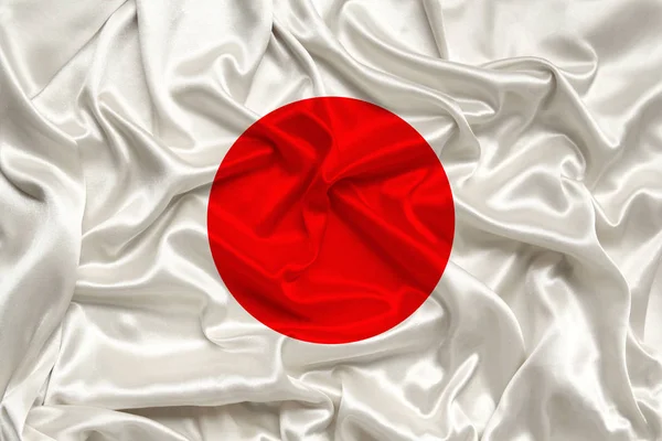 Bandera nacional del país Japón en suave seda con pliegues de viento, concepto de viaje, inmigración, política, espacio para copiar, primer plano — Foto de Stock