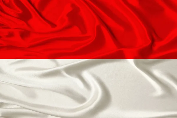 Hermosa foto de la bandera nacional de Mónaco e Indonesia en la delicada seda brillante con cortinas suaves, el concepto de poder estatal, la vida en el país, horizontal, primer plano, espacio de copia —  Fotos de Stock