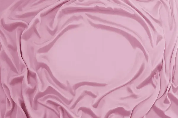 Fotografia tkaniny jedwabnej, kolor różowy. Tekstura tkaniny jedwabnej. Luksusowe tkaniny jedwabne tło z fal i draperii. Tło dla mody luksusowy design, zbliżenie, przestrzeń kopiowania — Zdjęcie stockowe