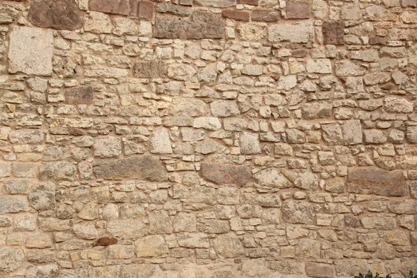 Rough sandy texture of an old medieval stone wall. Background for design, close-up, copy space — Stock Photo, Image
