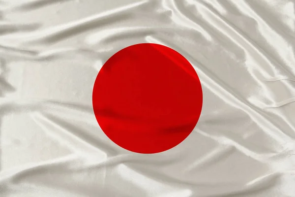 Bandera nacional del país Japón en suave seda con pliegues de viento, concepto de viaje, inmigración, política, espacio para copiar, primer plano — Foto de Stock