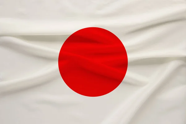 A bandeira nacional do país do Japão na seda suave com as dobras do vento, o conceito de viagem, imigração, política — Fotografia de Stock