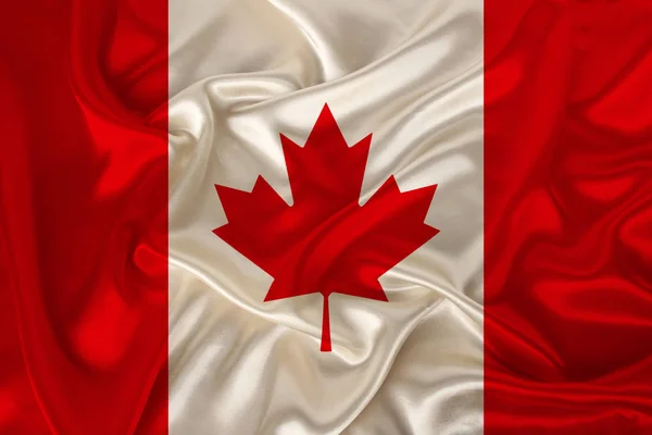 Photo du drapeau national du Canada sur une texture luxueuse de satin, soie avec vagues, plis et faits saillants, gros plan, espace de copie, illustration — Photo