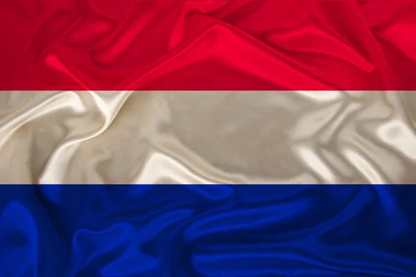 National flag of the country Holland on gentle silk with wind folds, travel concept, immigration, politics, copy space, close-up — Stock Photo, Image