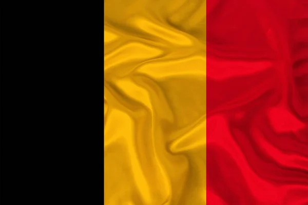 Photo of the national flag of Belgium on a luxurious texture of satin, silk with waves, folds and highlights, close-up, copy space, travel concept, economy and state policy, illustration — Stock Photo, Image