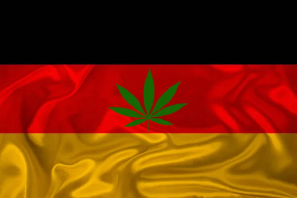 Grünes Hanfblatt und die schöne seidene Nationalflagge Deutschlands, das Konzept von medizinischem Cannabis, die Legalisierung von Drogen, Drogendelikte, Nahaufnahme — Stockfoto