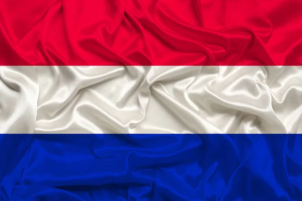 Nationale vlag van Nederland op zachte zijde met windvouwen, reisconcept, immigratie, politiek, kopieerruimte, close-up — Stockfoto