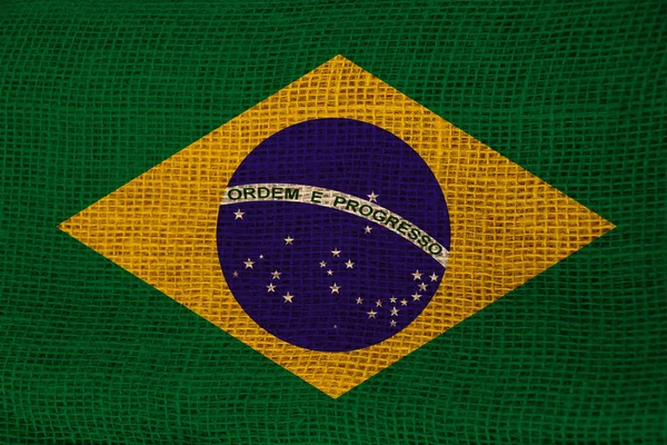 Foto van de nationale vlag van Brazilië op een luxueuze textuur van satijn, zijde met golven, plooien en highlights, close-up, kopieerruimte, reisconcept, economie en staatsbeleid — Stockfoto