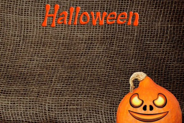 Halloween símbolo, abóbora sobre um fundo de lona natural, serapilheira com uma grande trama, fundo e textura, close-up, espaço de cópia — Fotografia de Stock