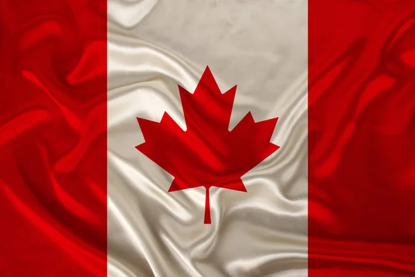 Photo du drapeau national du Canada sur une texture luxueuse de satin, soie avec vagues, plis et faits saillants, gros plan, espace de copie, illustration — Photo