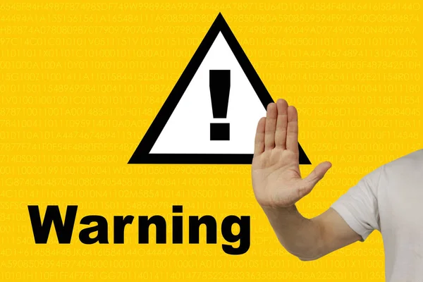 man shows a hand on an exclamation mark on a triangle, concept attention on a yellow technological background, concept Deceptive site ahead, horizontal, closeup, copy space