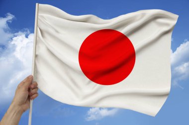 Modern Japonya devletinin dokulu kumaş, turizm, göç, ekonomi ve siyaset konsepti üzerindeki güzel renkli ulusal bayrağının fotoğrafı, yakın plan