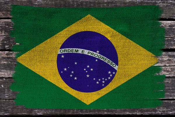 Foto da bandeira nacional do Brasil em uma textura luxuosa de cetim, seda com ondas, dobras e destaques, close-up, espaço de cópia, conceito de viagem, economia e política de estado, textura de jeans — Fotografia de Stock