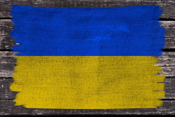 Foto av den vackra färgade nationella flaggan i den moderna staten Ukraina på texturerat tyg, begreppet turism, emigration, ekonomi och politik, närbild — Stockfoto
