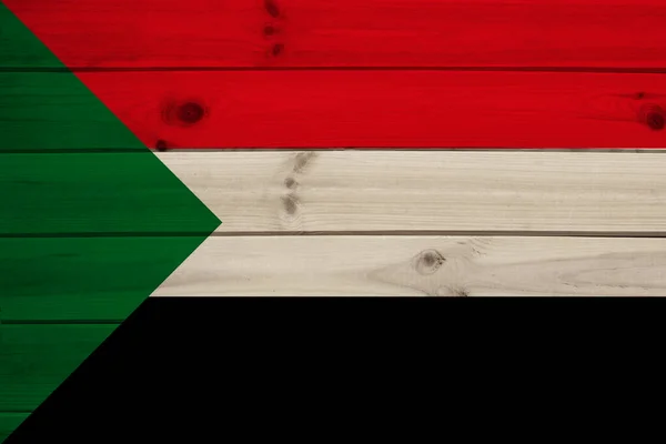Foto da bela bandeira nacional colorida do estado moderno do Sudão em um tecido texturizado, conceito de turismo, emigração, economia e política, close-up — Fotografia de Stock