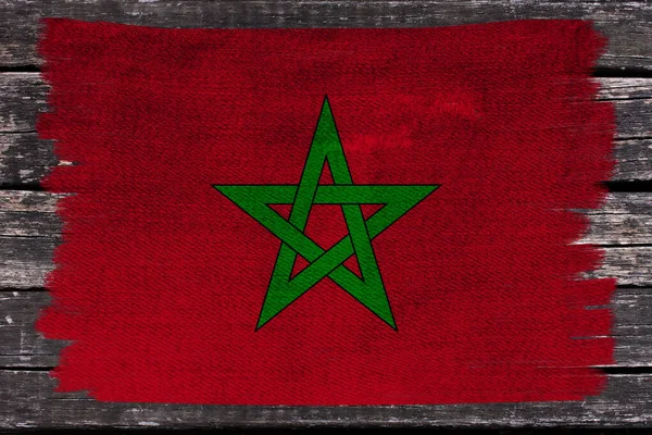 Photo of the beautiful colored national flag of the modern state of Morocco on textured fabric, concept of tourism, economics and politics, closeup — Stock Photo, Image