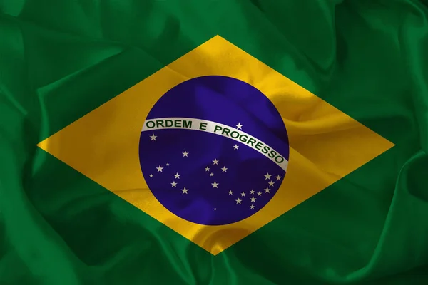 Bela foto da bandeira nacional colorida do estado moderno do Brasil sobre tecido textural, conceito de turismo, emigração, economia e política, close up — Fotografia de Stock