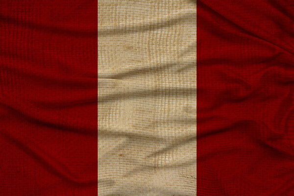 beautiful photo of the colored national flag of the modern state of Peru on textural fabric, concept of tourism, emigration, economy and politics, close up